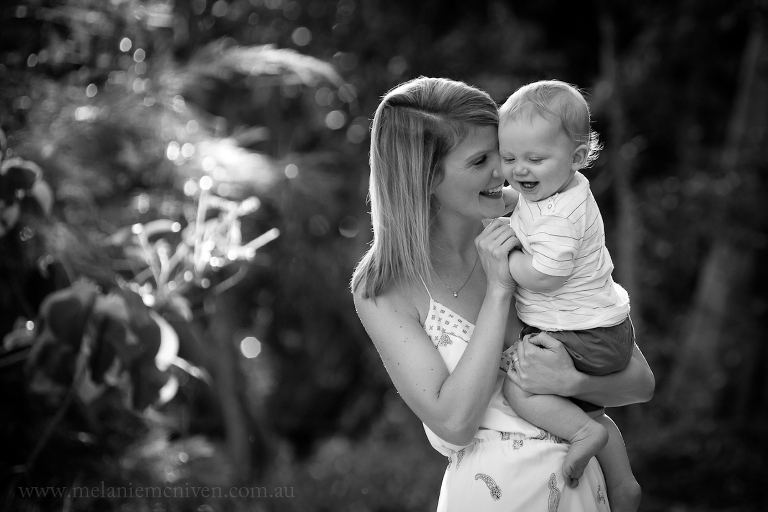 family portraits Noosa. A mum cuddling her son while he is laughing. 