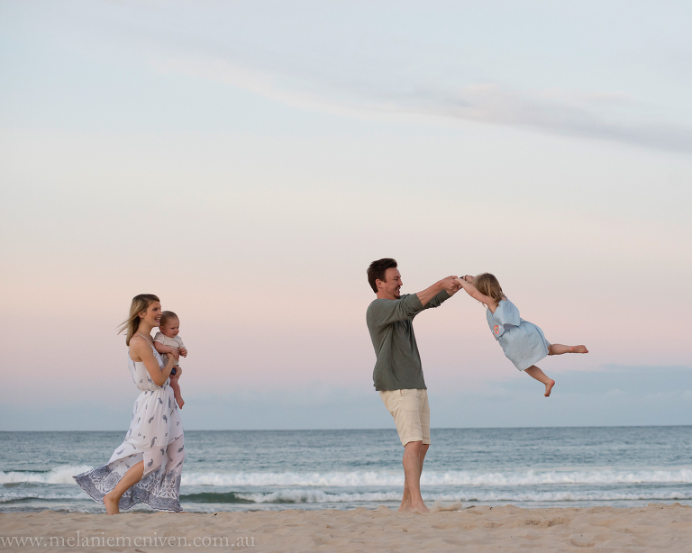 A family having fun at noosa beach playing games