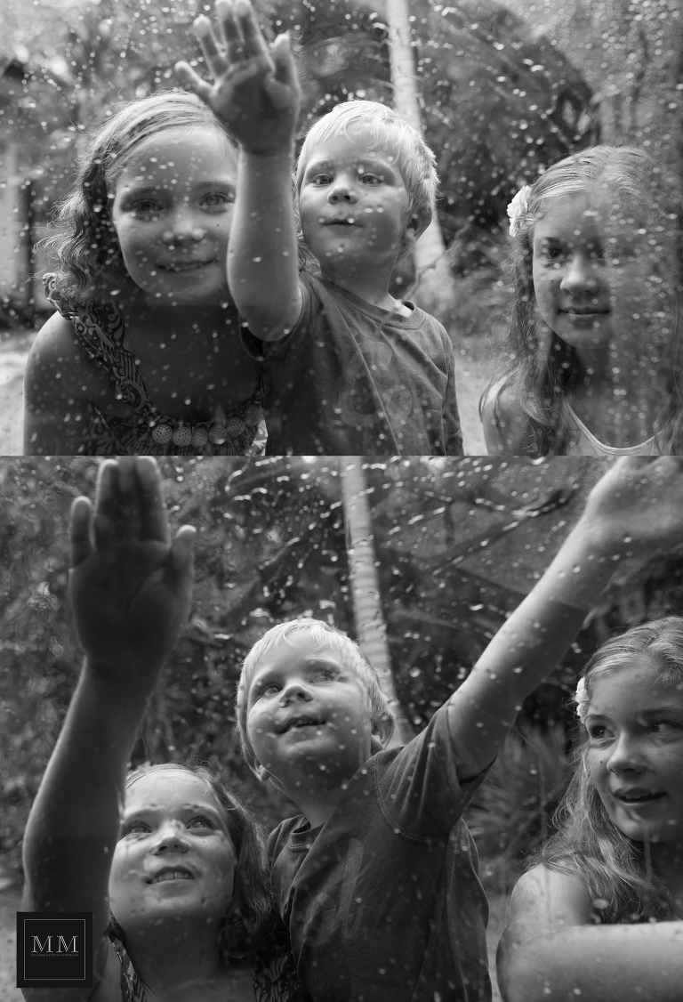 Children playing with raindrops