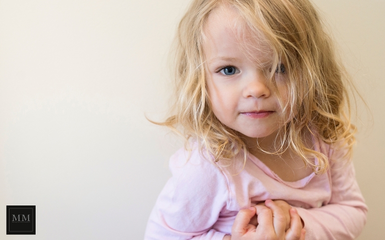 Little girl on a white wall