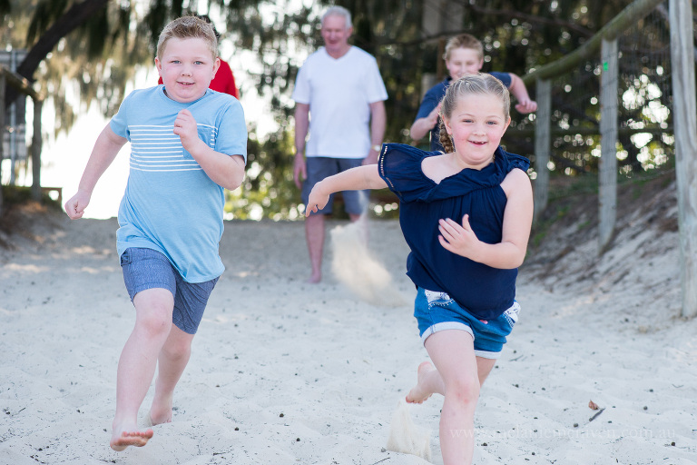 kids running down surfers paradise beach