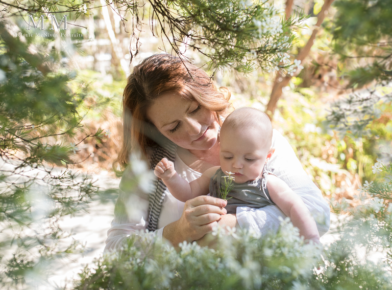 Mum and baby session smelling flowers in the park